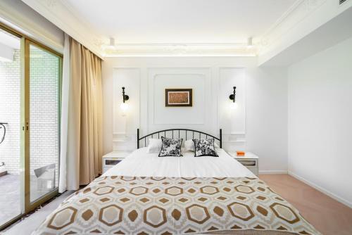 a bedroom with a large bed with two pillows at Shanghai Yi Du B&B - Yu Garden Bund Store, 400m near Yu Garden subway in Shanghai