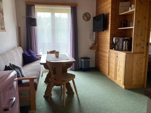 a living room with a table and a couch at Ellmauhof in Pfarrwerfen