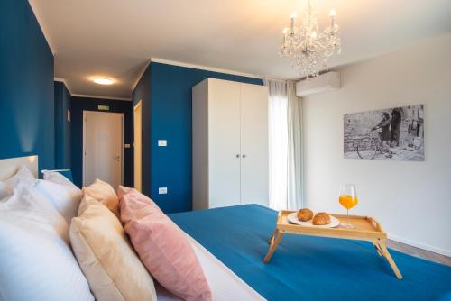 a bedroom with blue walls and a bed with a table at Vinkuran by Bura Hotels - Adults Only in Pula