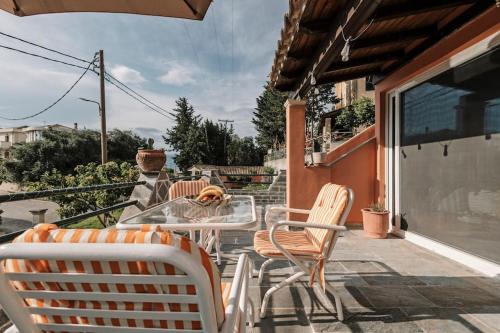 a table and chairs on a patio with a view at Cocoa in Potamós
