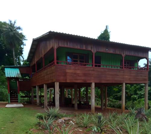 a large wooden house with a balcony at Casas Salomão in Santo António
