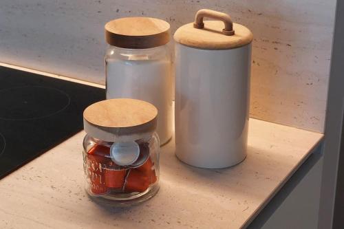 two mason jars sitting on a wooden shelf at Trendy flat in gouden winkeldriehoek nabij strand in Knokke-Heist