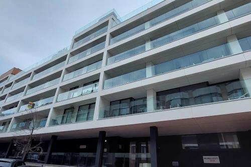 a large building with a man standing on the balcony at Trendy flat in gouden winkeldriehoek nabij strand in Knokke-Heist