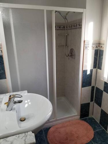 a bathroom with a white sink and a shower at Beautiful 3 Bed 3 & a half Bath Home with Pool & Dock Slip in Freeport
