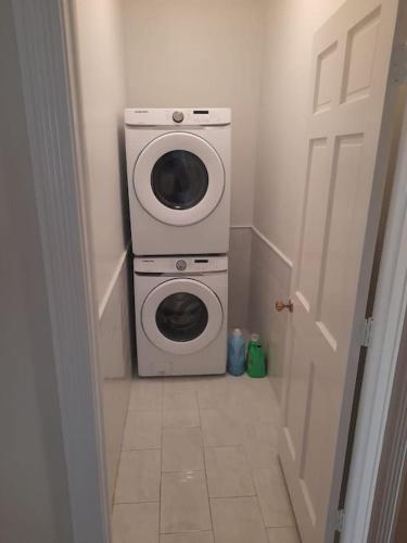 a washer and dryer in a small room at Beautiful 3 Bed 3 & a half Bath Home with Pool & Dock Slip in Freeport