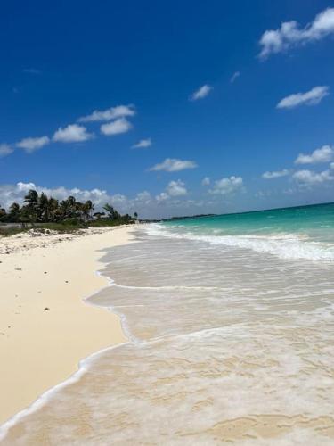 a beach with the ocean and the waves at Beautiful 3 Bed 3 & a half Bath Home with Pool & Dock Slip in Freeport