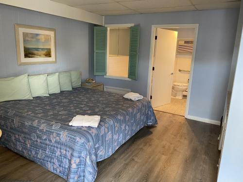 Ένα ή περισσότερα κρεβάτια σε δωμάτιο στο Beau Rivage Motel