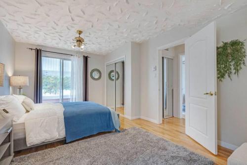 a bedroom with a bed and a white ceiling at Riviera Escape on Waterfront with Hot Tub in Gatineau