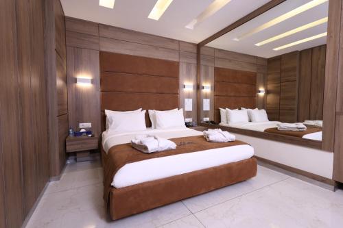 two beds in a hotel room with two bedsvisor at Ibiza Hotel in Jounieh