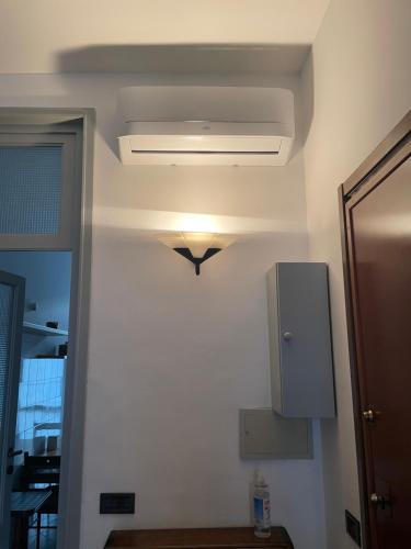 a room with a light on the ceiling of a room at Lake & The City in Como