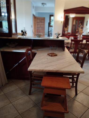 a wooden table and chairs in a kitchen at Zeusplace karia Villa Natura in Leptokaria