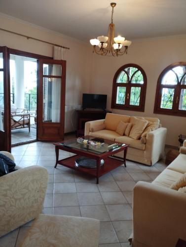 a living room with a couch and a coffee table at Zeusplace karia Villa Natura in Leptokaria