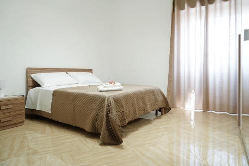 a bedroom with a bed and a wooden floor at Vesuvius Home in Trecase
