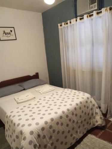 a bedroom with a bed with polka dots on it at Sintonia do Mar in São Francisco do Sul