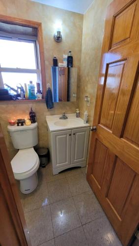 a bathroom with a toilet and a sink at New York in Woodside