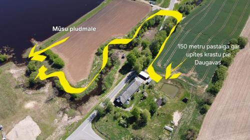 a site map of a farm with yellow arrows at Bajāri - Pirts - Banya in Svente