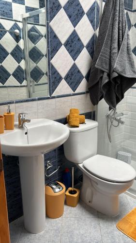 a bathroom with a toilet and a sink at Pool Front Playmar Maspalomas in San Bartolomé