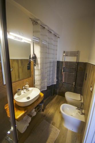 a bathroom with a sink and a toilet at B&B Il Quadrifoglio in Portici