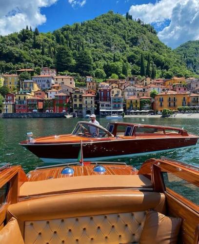 a man in a boat on a body of water at Anzio 9 Guest House in Lecco