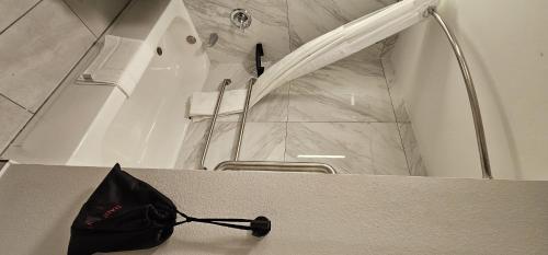 a black bag sitting on top of a counter in a bathroom at Wyndham Garden Atlanta Airport in Atlanta