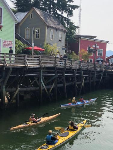 a group of people in kayaks in the water near a dock at Inn At Creek Street in Ketchikan