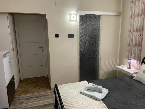 a bedroom with a bed and a door with a towel on it at Goga in Pula