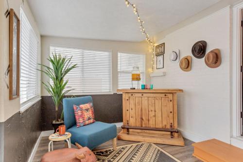 a living room with a blue chair and a table at Backyard BBQ Retreat: Central 3bd - Prime Location in Arvada