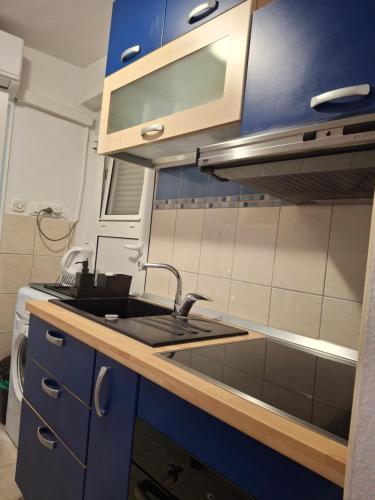 cocina con fregadero y armarios azules en Old town apartment Nina 1, en Split