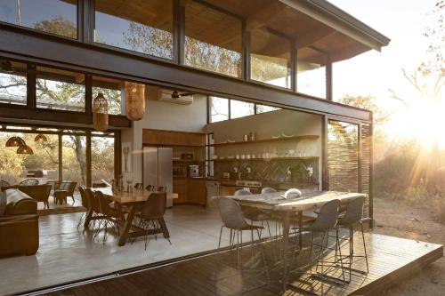 an open kitchen and dining room of a house at Rixile Kruger Lodge in Skukuza