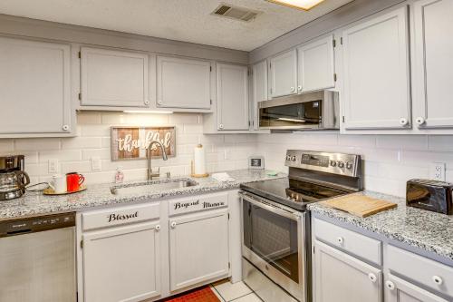 a kitchen with white cabinets and stainless steel appliances at 2 Mi to Ski Resort! Sugar Mtn Condo with Indoor Pool in Sugar Mountain