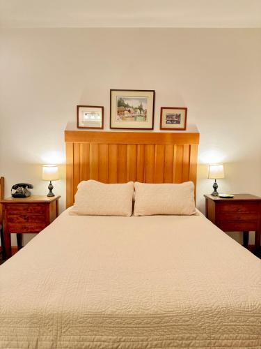 a bedroom with a large bed with two night stands at Inn At Creek Street in Ketchikan