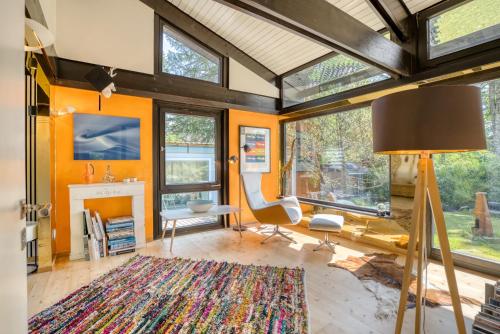 ein Wohnzimmer mit orangefarbenen Wänden und einem Kamin in der Unterkunft Ferien-Chalet-Walchensee in Walchensee