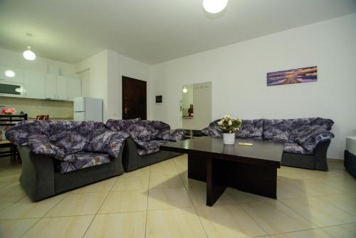 a living room with a large couch and a table at Harris&Arvien Apartment's in Vlorë