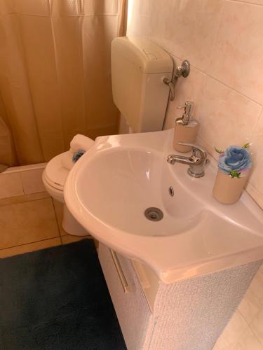a bathroom with a white sink and a toilet at Casa vacanze Emiliana in Ragusa