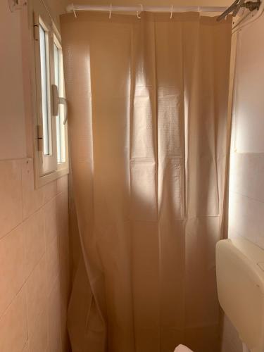 a bathroom with a shower with a shower curtain at Casa vacanze Emiliana in Ragusa