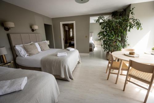 ein Hotelzimmer mit 2 Betten und einem Tisch in der Unterkunft Coastal View House in Doolin