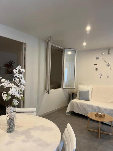 a bedroom with a bed and a table and chairs at La Mhirabelle in Saint-Paul-de-Vence