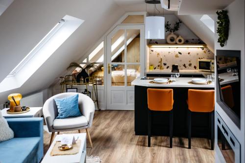 a kitchen and living room with an attic at Nook with a view - Quelle in Győr