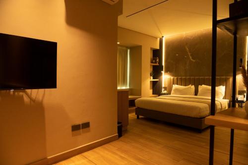 a bedroom with a bed and a flat screen tv at Vertigo Hotel in Lagos