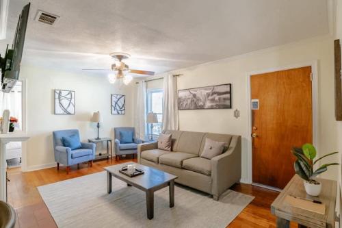 a living room with a couch and a table at Close to Midtown & Parks - Little Blue in Mobile