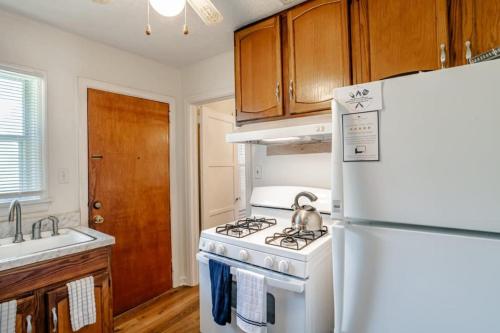 a kitchen with a white stove and a refrigerator at Close to Midtown & Parks - Little Blue in Mobile