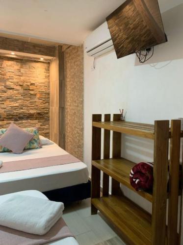 Postel nebo postele na pokoji v ubytování Hostal Catalleya
