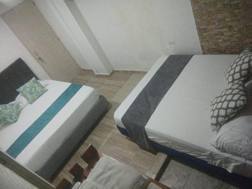 Postel nebo postele na pokoji v ubytování Hostal Catalleya