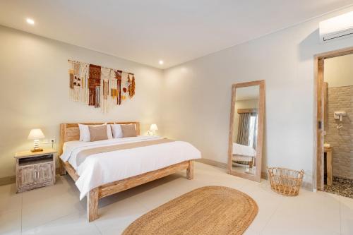 a bedroom with a large bed and a mirror at ☆ Villa Larissa ☆ Seminyak 2BR Pool Kuta Petitenget in Seminyak