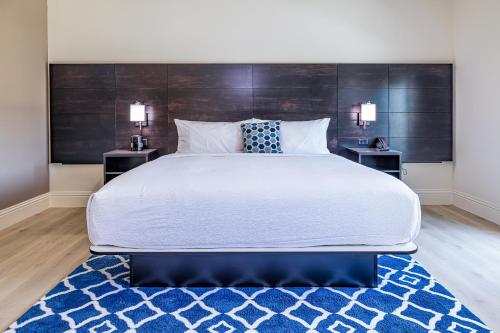 a bedroom with a large bed with two night stands at Grant Street Inn, an Ascend Collection Hotel in Dunedin