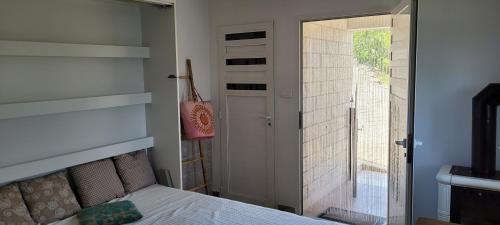 a bedroom with a bed and a sliding glass door at PERFECT NEST at Sunset Beach in Vela Luka