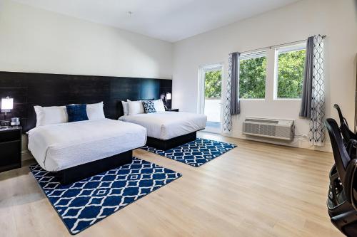 a bedroom with two beds and a large window at Grant Street Inn, an Ascend Collection Hotel in Dunedin