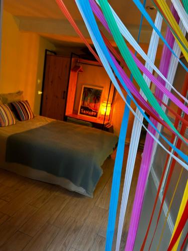 a bedroom with a bed with colorful streamers at Cabanon à Sanary sur mer au coeur de Portissol. in Sanary-sur-Mer