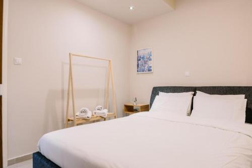 a bedroom with a white bed and a mirror at Xanthi's House in Xanthi