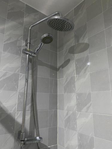 a shower with a shower head in a bathroom at T1 Férias Mindelo in Mindelo